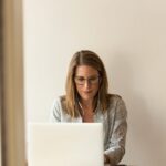 Woman Sitting While Using Laptop